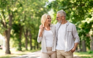 A senior couple discussing Medicare benefits while holding hands, with a focus on how marriage may affect their Medicare coverage.
