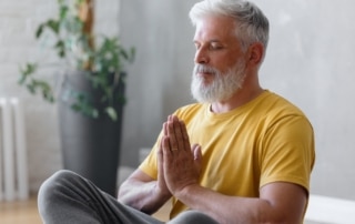 Senior engaging in outdoor wellness activities, such as walking in nature, which contributes to overall senior wellness and healthy aging.