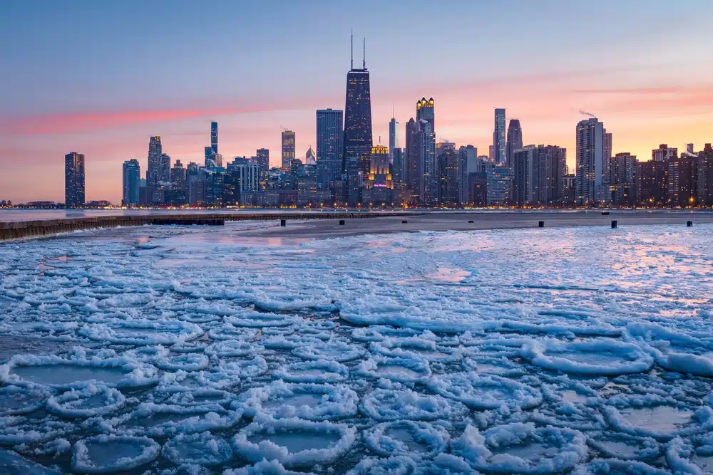 A frozen lake Michigan looking at the Chicago skyline. 