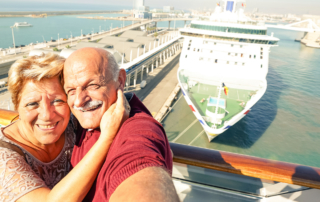 Cruises fro seniors: Senior couple with ocean liner in background