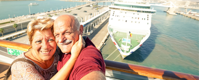Cruises fro seniors: Senior couple with ocean liner in background