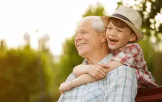 Grandson hugging his grandfather, emphasizing Alzheimer's awareness and dementia care education