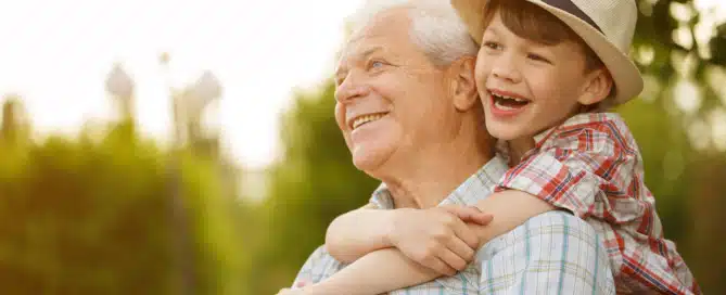 Grandson hugging his grandfather, emphasizing Alzheimer's awareness and dementia care education