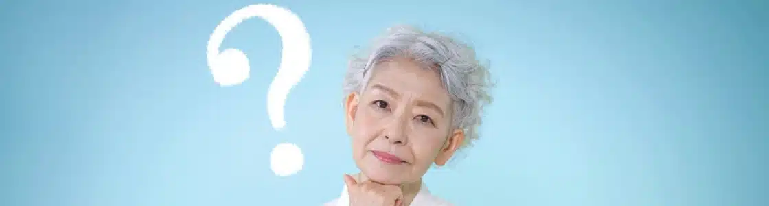 Senior FAQ Magnifying glass focusing on the word 'Medicare' surrounded by various healthcare-related terms, representing common Medicare FAQs